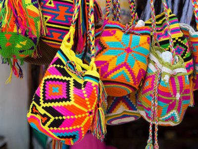 Guatape, Colombia - March 12, 2015: Women fashion accessories, Various items of crocheted bucket-style handbags, Wayuu handcrafted mochilas woolen bags, Colombia - street market / Fashion - Crochet handbags